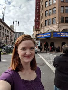 Kelsey standing in front of the Golden Gate theatre in San Francisco before a performance of Come From Away.